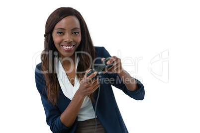 Portrait of businesswoman playing video game