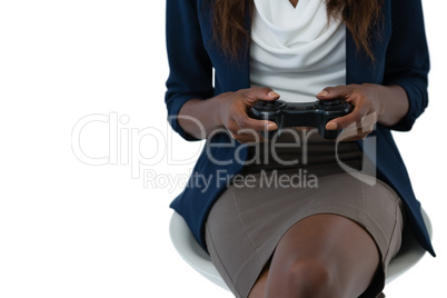 Mid section of businesswoman playing video game