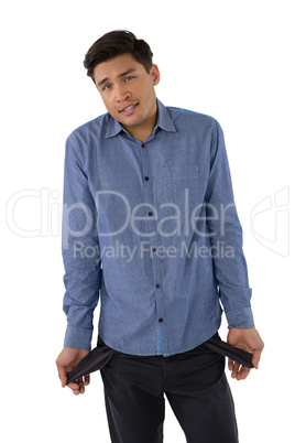Portrait of businessman showing empty pockets