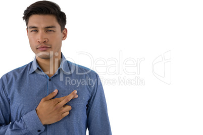 Portrait of young businessman with fingers crossed