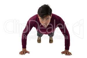 Portrait of young businessman doing push ups