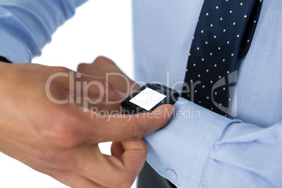 Mid section of businessman using smartwatch