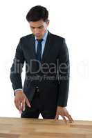 Businessman gesturing while standing by table
