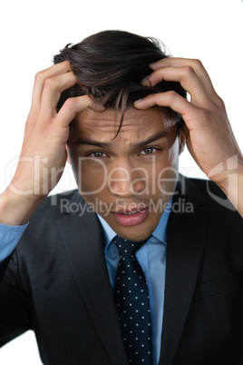 Portrait of frustrated businessman with head in hand