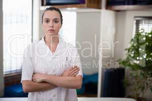 Portrait of confident female therapist standing with arms crossed