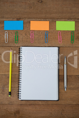 Various school supplies arranged on wooden table