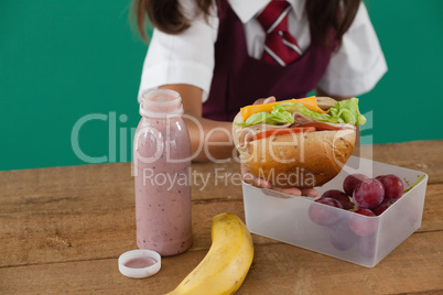 Schoolgirl having sandwich