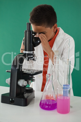 Schoolboy using microscope