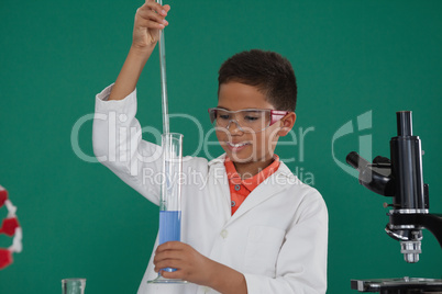 Attentive schoolboy doing a chemical experiment in laboratory