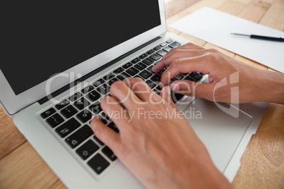 Businesswoman using laptop on the table