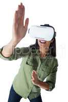 Woman gesturing while using virtual reality headset