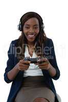 Woman wearing headphones while playing video game