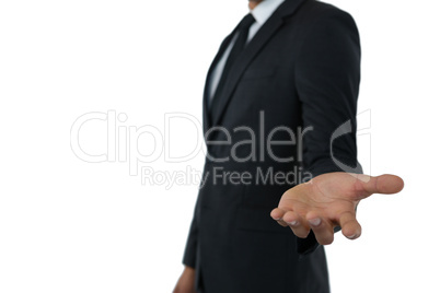 Mid section of businessman extending arm