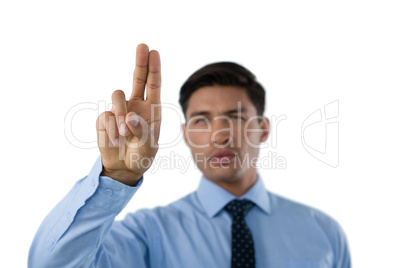 Young businessman touching invisible screen