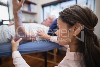 Close-up of female doctor examining elbow