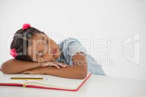 Young girl sleeping with her head on desk