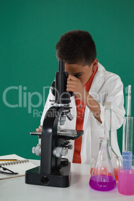 Schoolboy using microscope