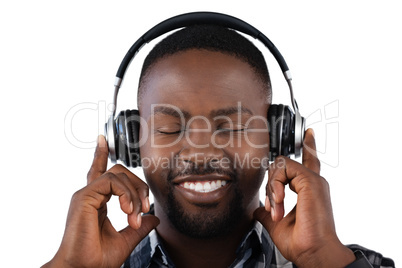 Man listening to music on headphones against white background