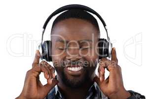 Man listening to music on headphones against white background