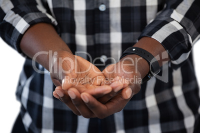 Man standing with hands cupped against white background