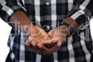Man standing with hands cupped against white background