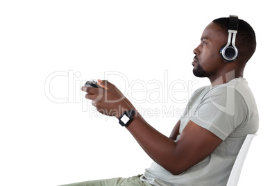 Man playing video game against white background