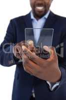 Businessman holding a glass smartphone