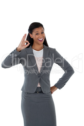 Businesswoman gesturing okay hand sign