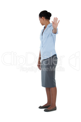Businesswoman showing her hand while ignoring