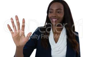 Smiling businesswoman using interface screen against white background