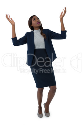 Businesswoman gesturing while tiptoeing