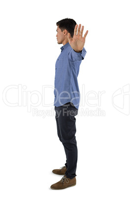 Side view of man showing stop gesture