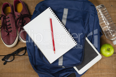 Bagpack, Diary, shoes, spectacles, digital tablet, apple and water bottle