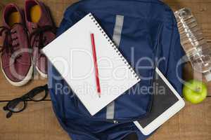Bagpack, Diary, shoes, spectacles, digital tablet, apple and water bottle