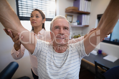 Male patient and female doctor with arms raised