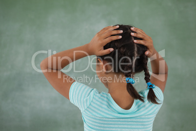 Young girl holding her head