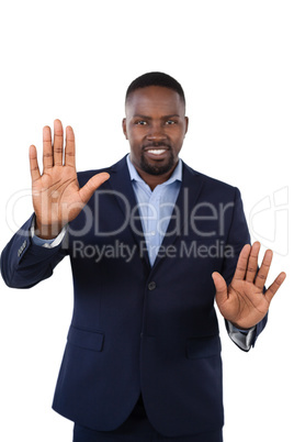 Smiling businessman touching the invisible screen