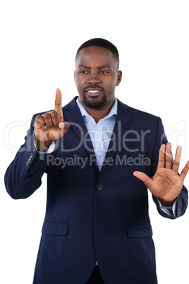 Businessman pressing an invisible virtual screen