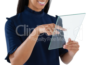 Female executive using a glass digital tablet