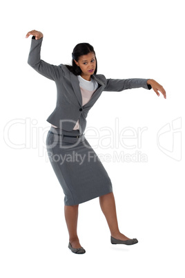 Businesswoman dancing against white background