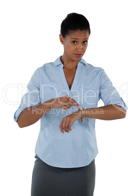 Businesswoman pointing at her wristwatch