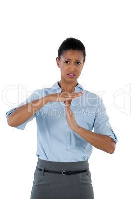 Irritated businesswoman making a timeout hand gesture