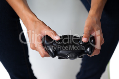 Woman playing video game against white background