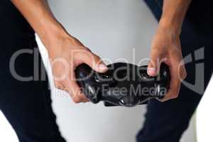 Woman playing video game against white background