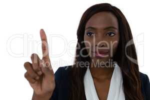 Confident businesswoman touching imaginary screen