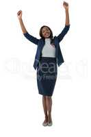 Portrait of happy businesswoman with arms raised