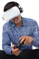Young businessman using vr glasses while playing video game