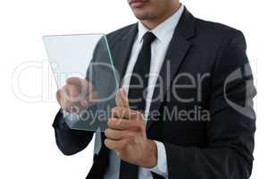 Mid section of businessman touching transparent interface