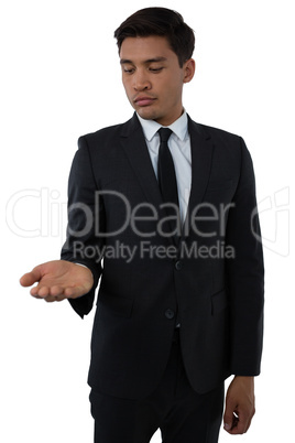 Young businessman looking at palm of hand