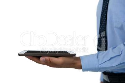 Mid section of businessman holding tablet